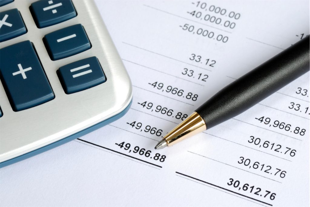 Bank records forming part of a SME working capital loan application, along with a pen and calculator