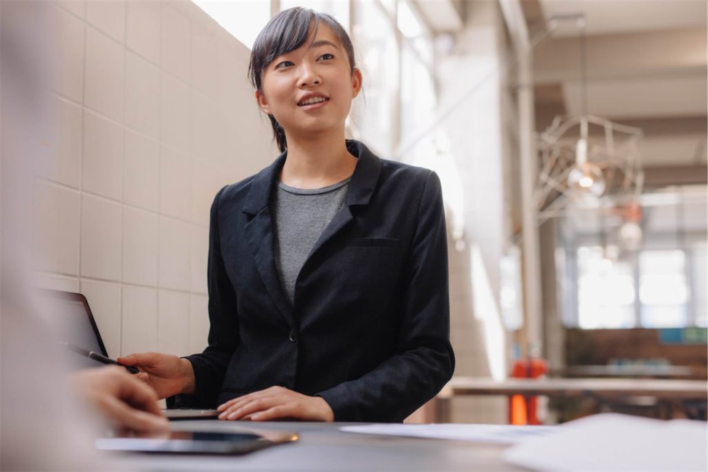 Confident asian business woman giving presentation