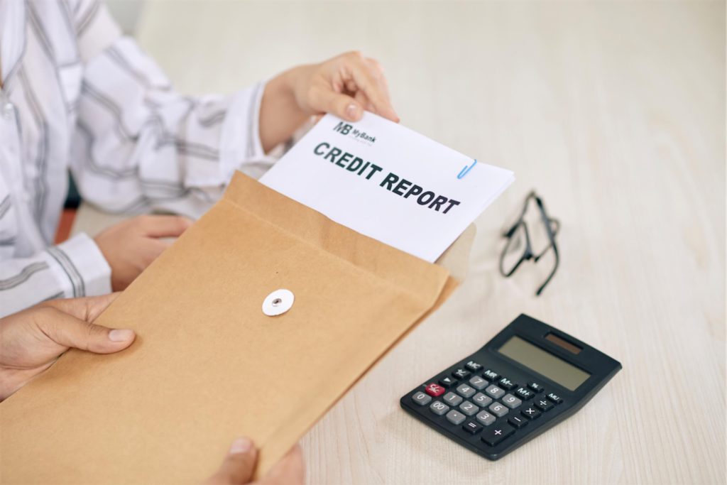 woman showing credit report papers to client