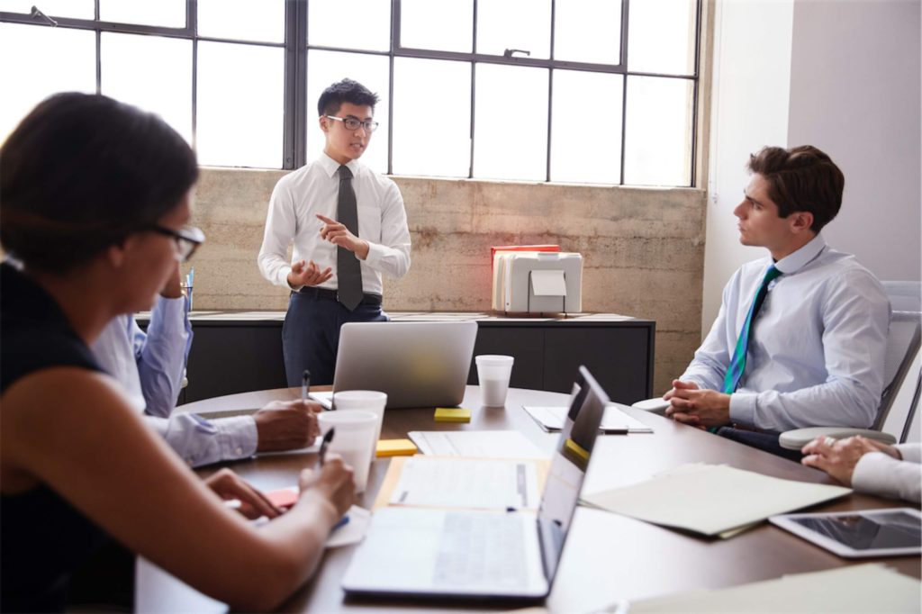 young-asian-businessman-addressing-colleagues