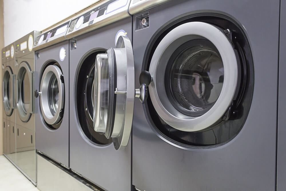 Row of washing machines in a laundromat, which could be a feasible small business opportunity in Singapore 