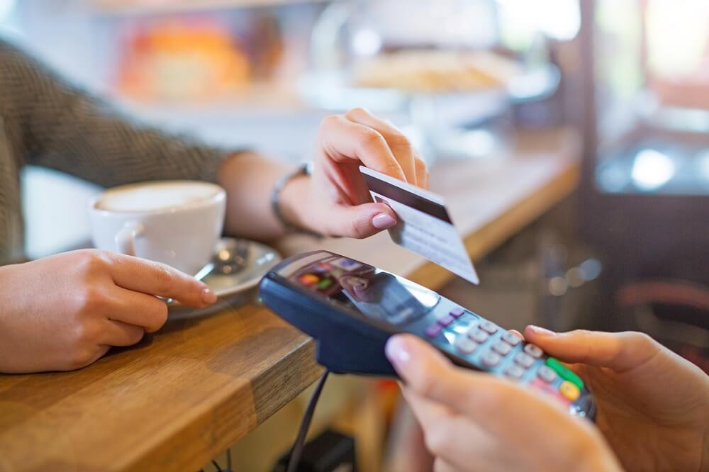 Man making card payment to a credit card processor wired up on merchant cash advance plan