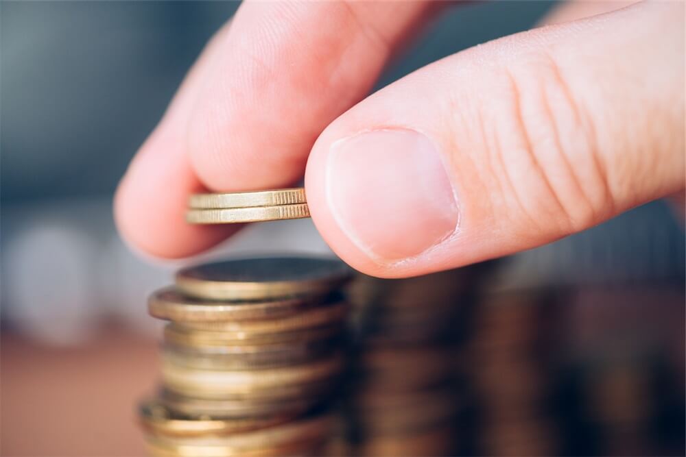 Man putting coins in a stack