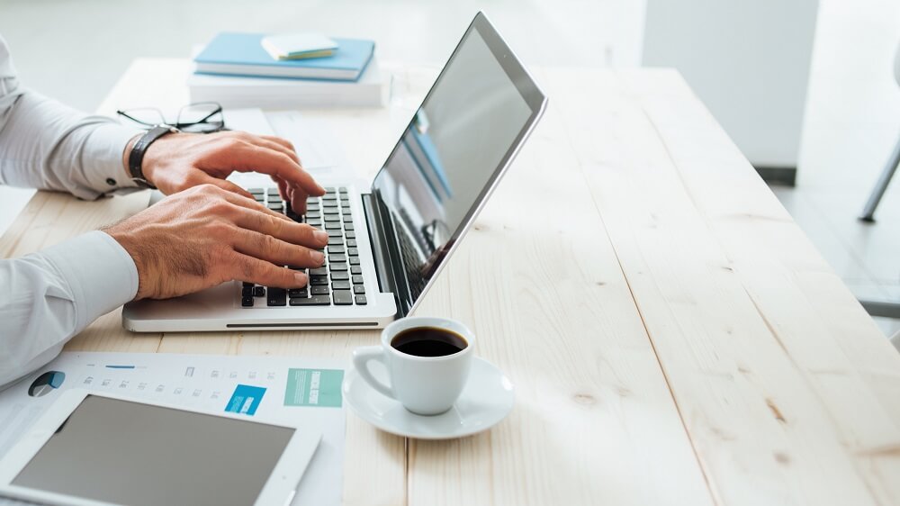 An SME loan broker working on a laptop