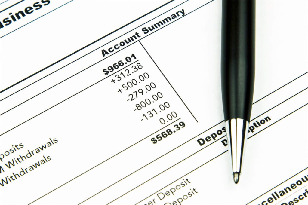 Paper showing bank account summary and deducting monthly car loan payment