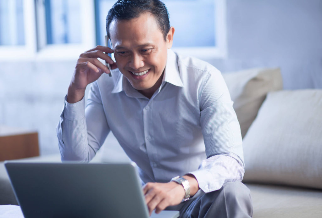 A business owner calling a lender to enquire about hire purchase car loans for his business