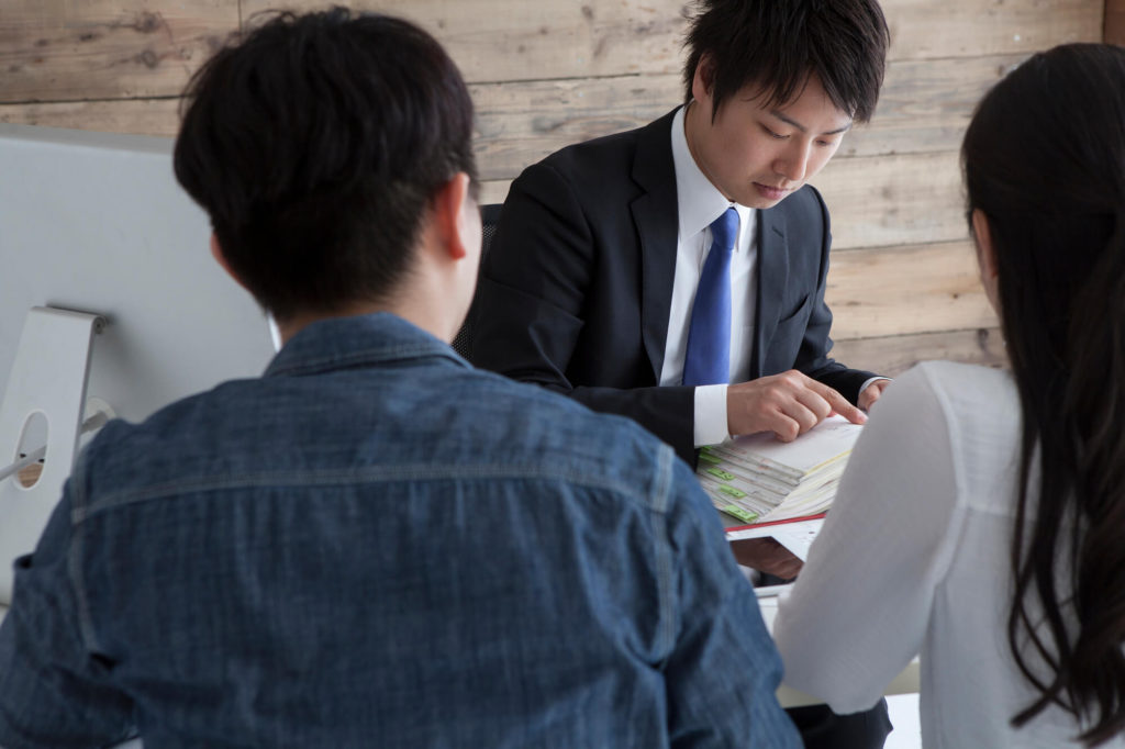 Financial advisor helping two business owners with their hire purchase plan