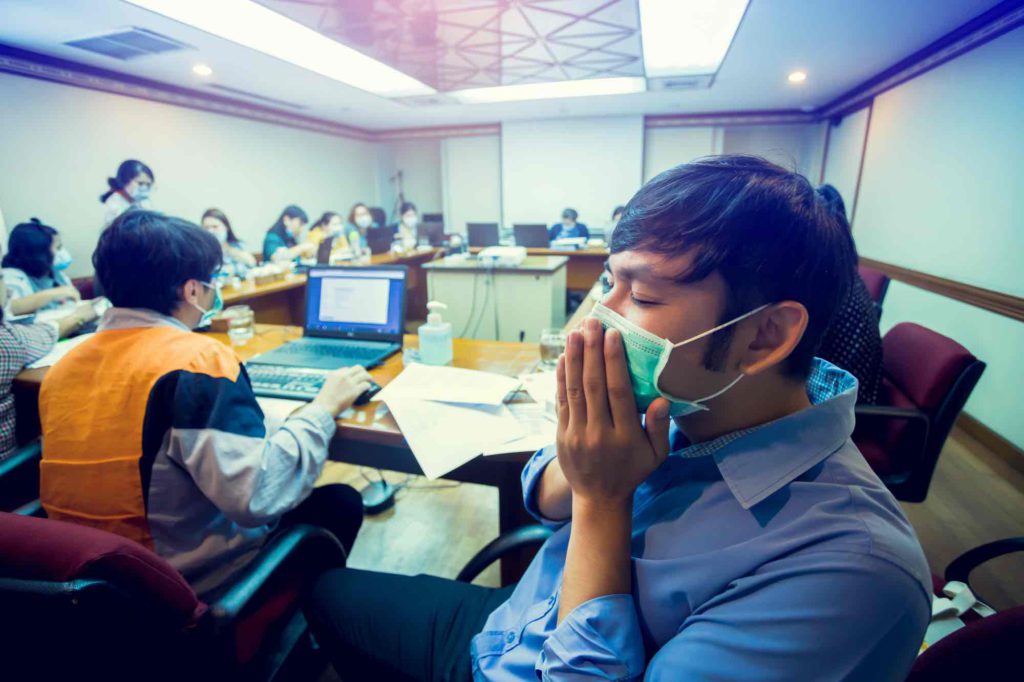 Employees wearing masks in a conference room