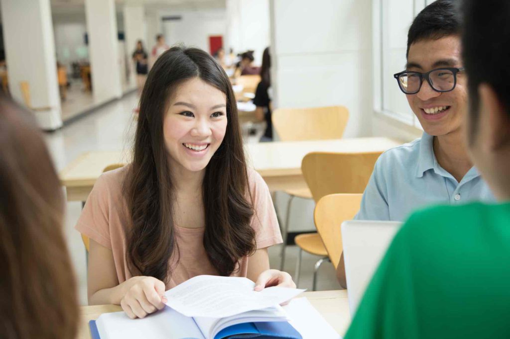 Young employees reviewing learning material after an external training class.