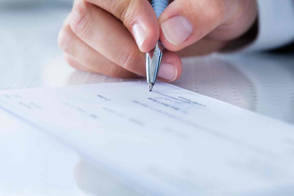 Business owner signing a cheque