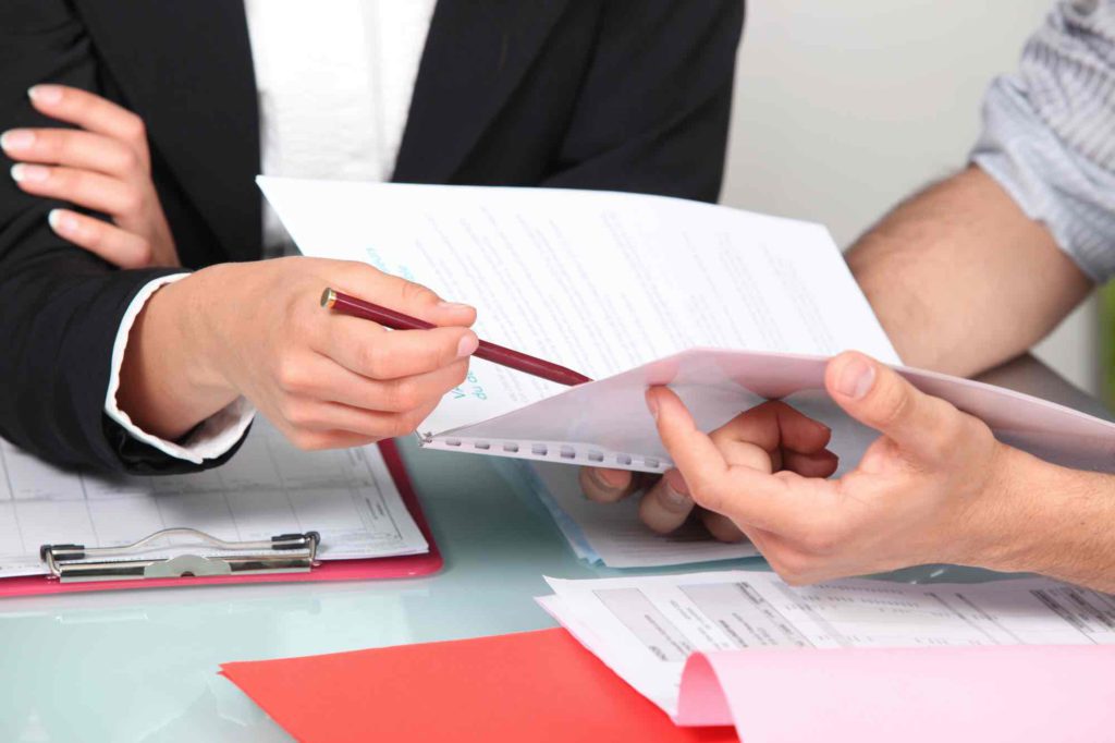 Two individuals going through a legal document